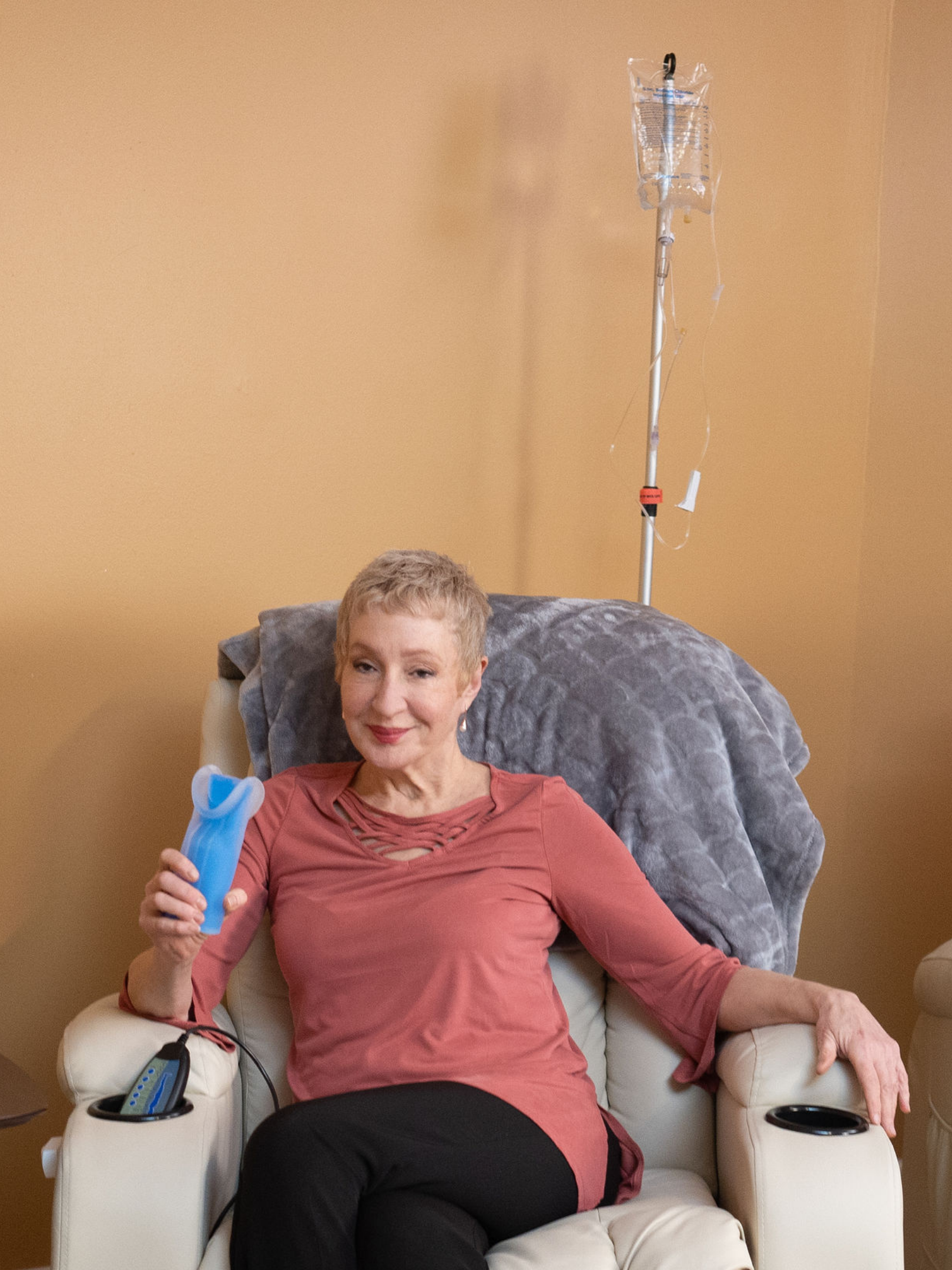 Woman sitting with Chemo Mouthpiece device
